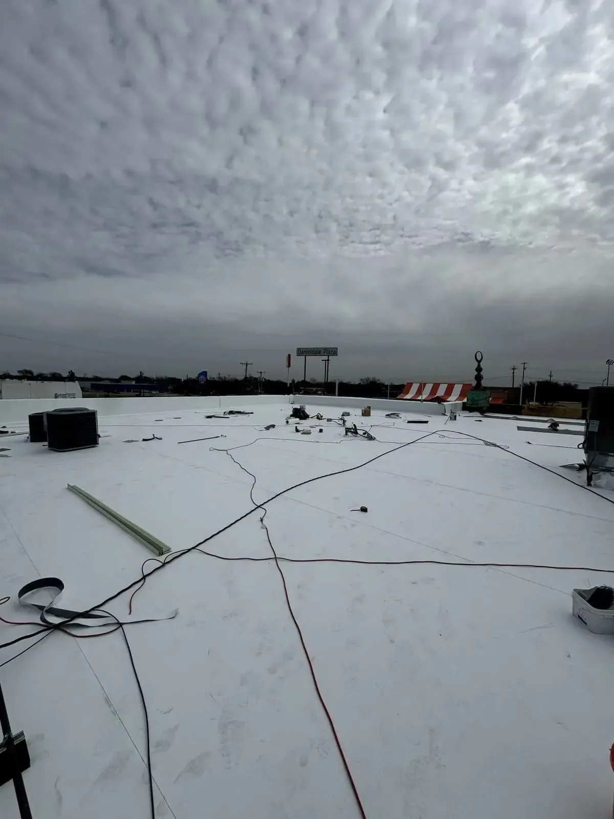 Wind-damaged commercial roof membrane Wind-damaged commercial roof membrane